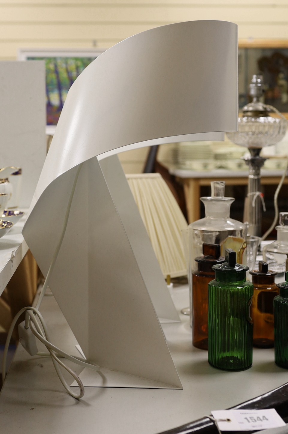 Two white painted metal sculptural table lamps, 48cms high